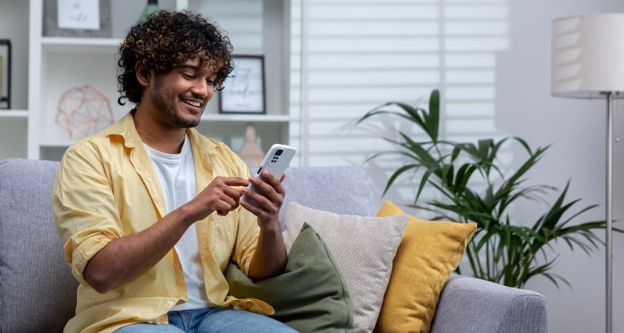 Resident accessing a home security app on his cell phone